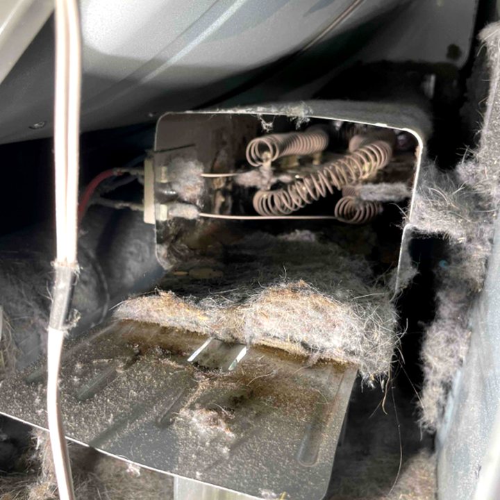 Lint buildup inside dryer heating element housing